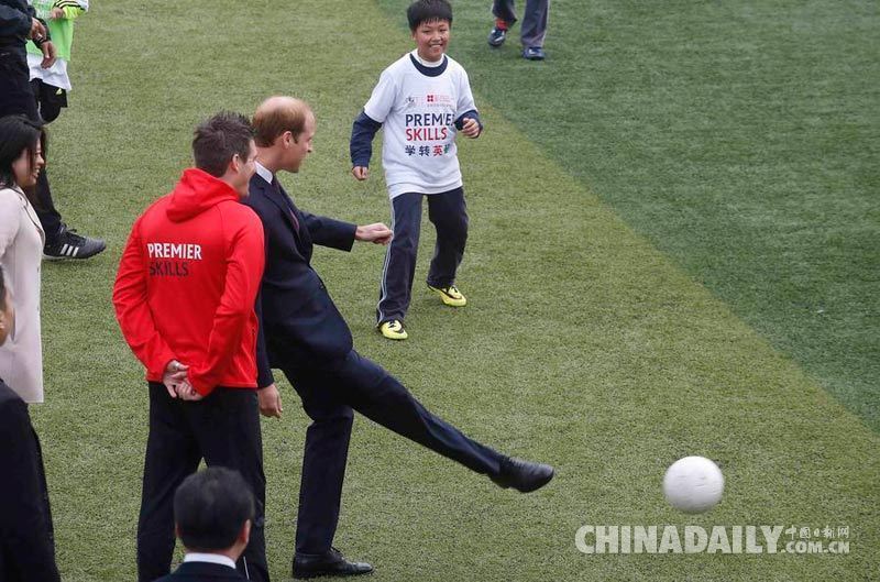 威廉王子访问上海南洋中学 亲自示范踢球与小球员击掌